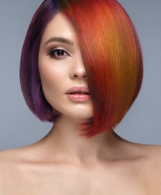 Portrait of beautiful woman with multi-colored hair and creative make up and hairstyle.